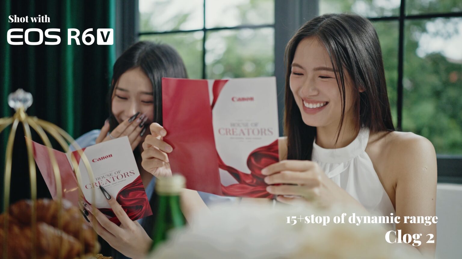 Two attendees leafing through a Canon booklet at the launch event.